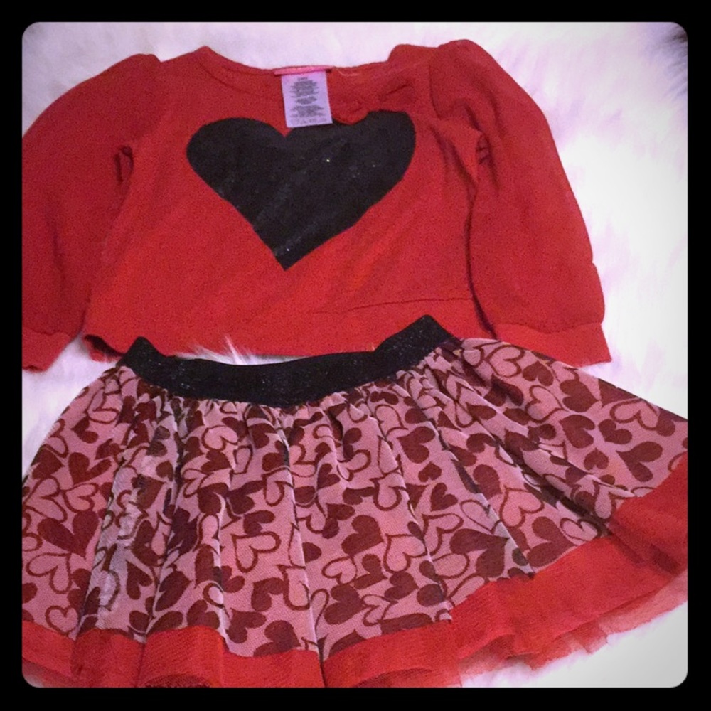 Matching outfit with skirt and long sleeve shirt.